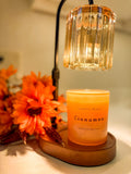 Cinnamon beeswax candle by Created by Madison glowing under a candle warmer with fall flowers