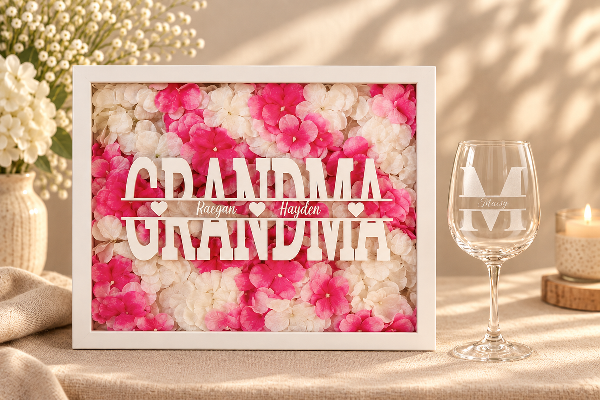 The Gift for Her bundle — personalized floral shadowbox as the focal point with a monogram etched stemmed wine glass as an accent, styled as an elegant gift set