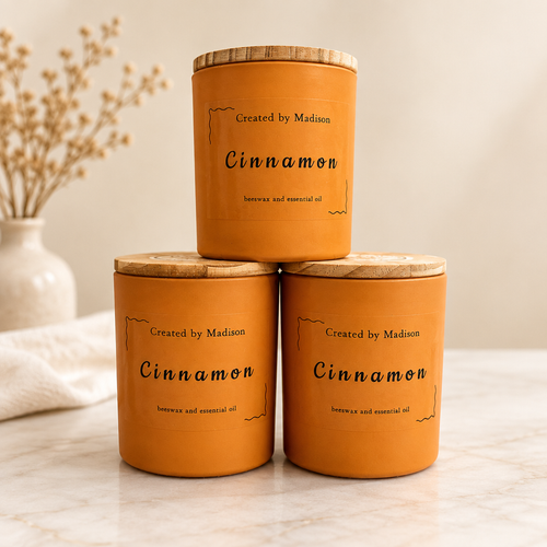 Three Cinnamon beeswax candles by Created by Madison on a clean neutral background